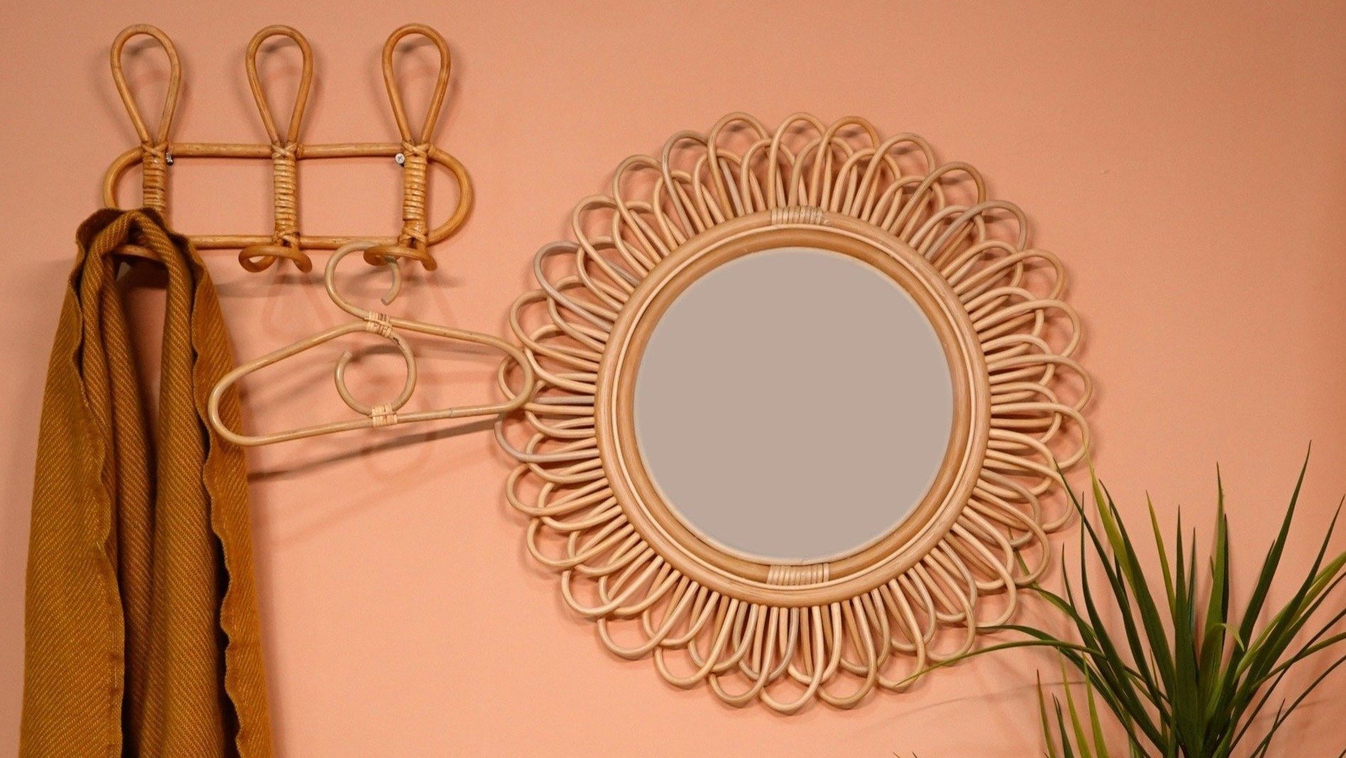 rattan mirror hanging by a wall in room
