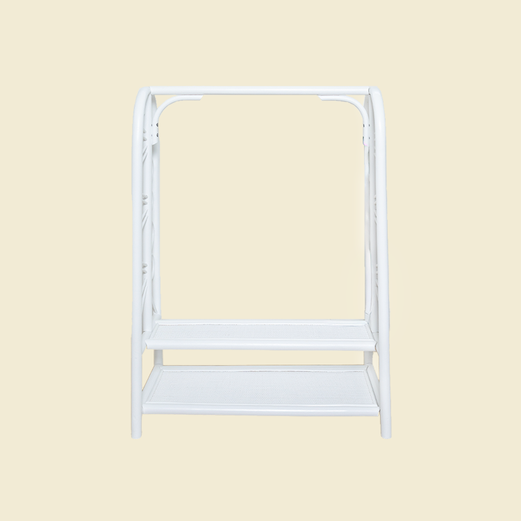 Front view of the handcrafted white rattan Belle Kids Montessori Clothing Rack by MOMIJI, featuring decorative side details, a child-friendly hanging rail, and two practical storage shelves.