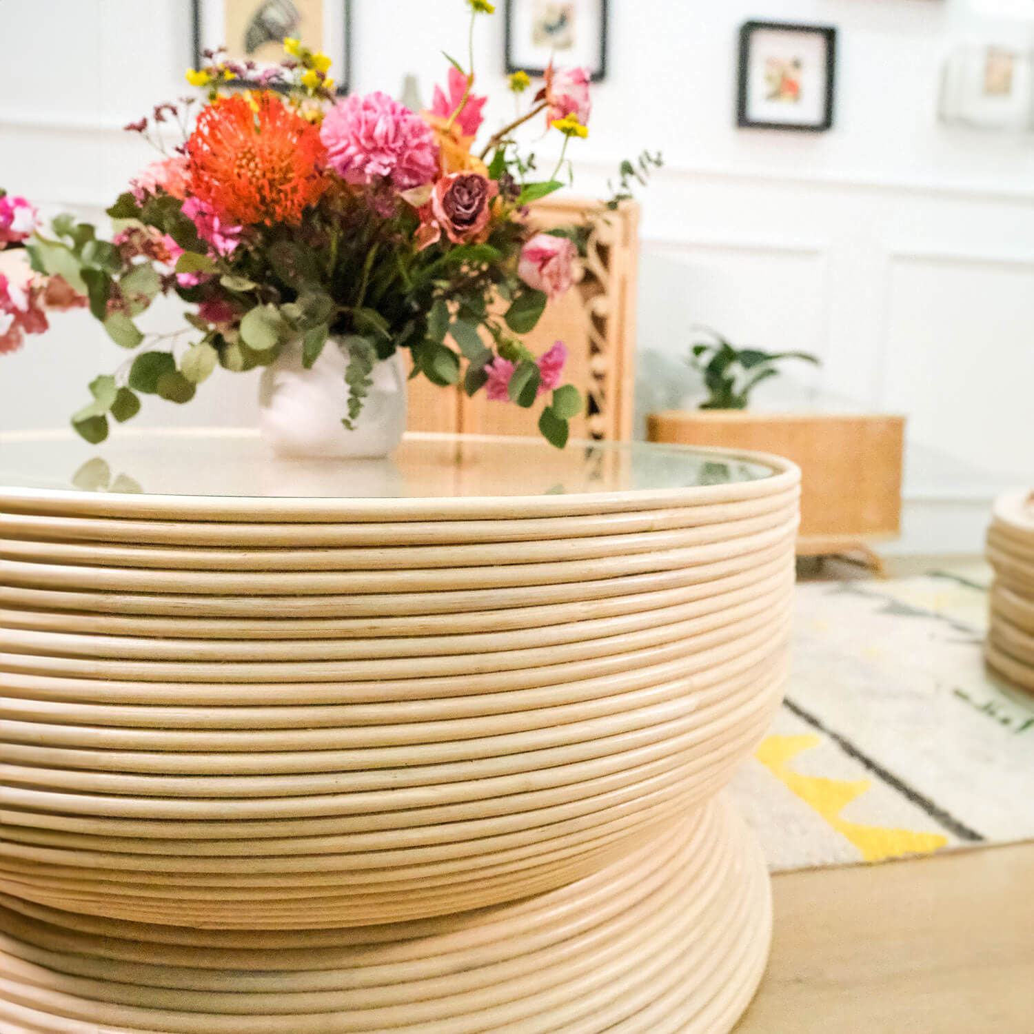 Close-up view of the Charme Coffee Table by MOMIJI with a vase placed on top.