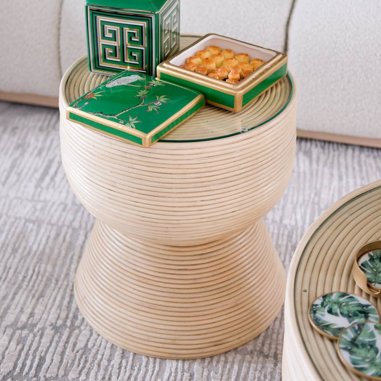 Charme Side Table by MOMIJI styled with a box of cookies on a rug in an indoor setting.