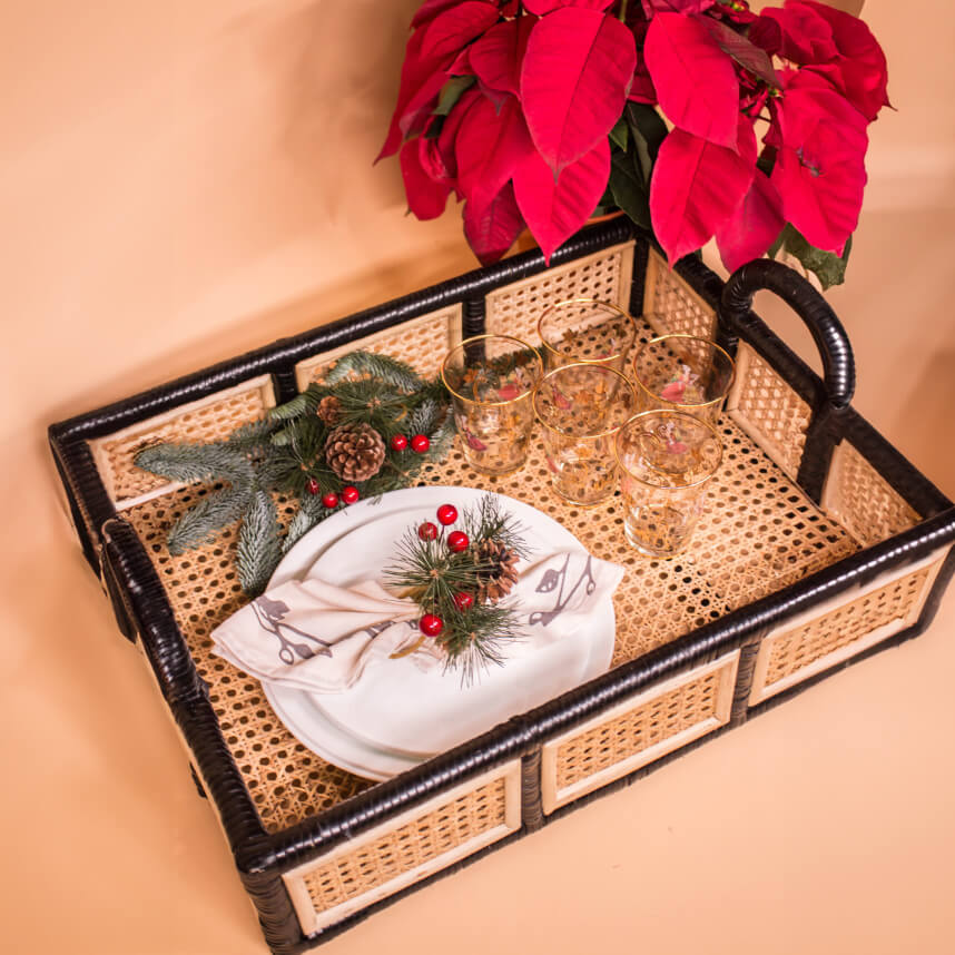 Top view of the Coco Serving Tray by MOMIJI, highlighting the contrast of black rattan structure with natural woven rattan detailing, styled with decorative accessories.