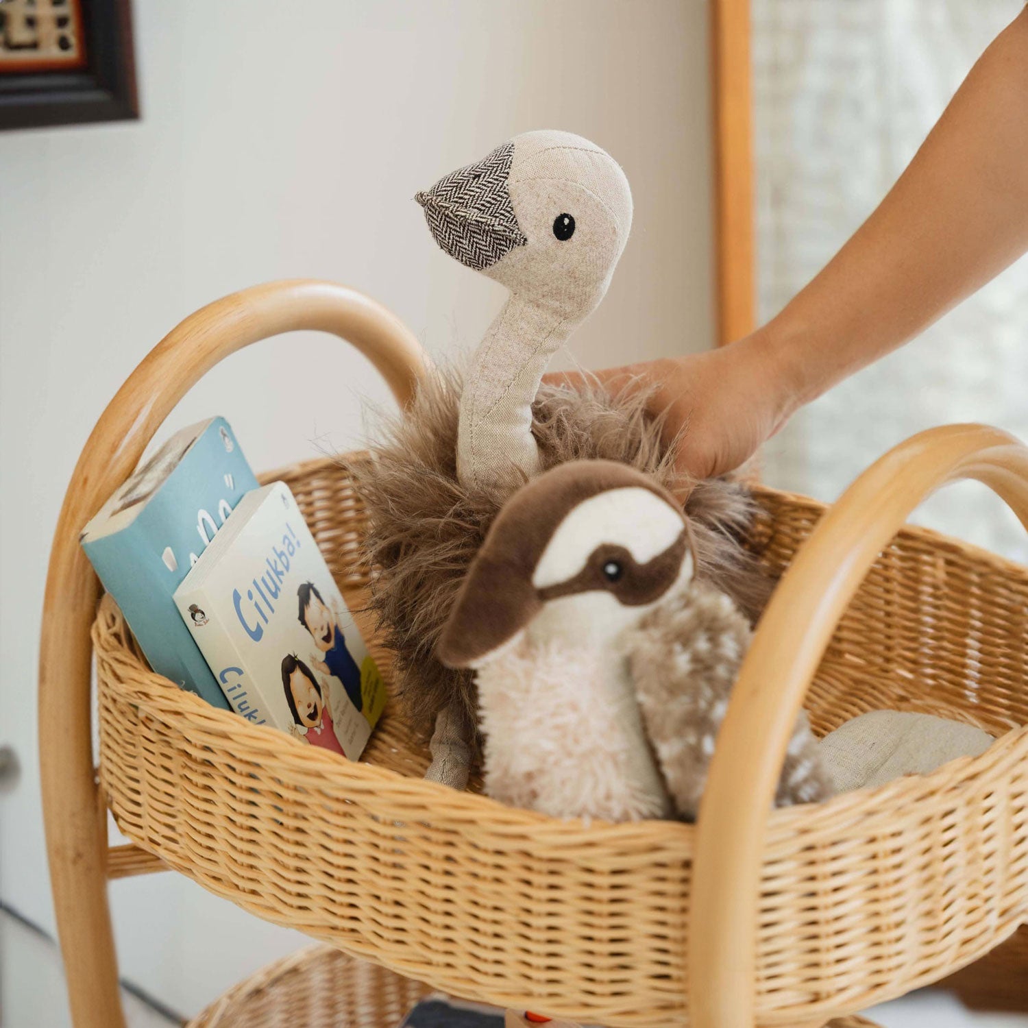 Handcrafted rattan wicker Con Craft Trolley shelf by MOMIJI filled with plush toys and books, detailing integrated handles and woven basket design for organized kids storage.