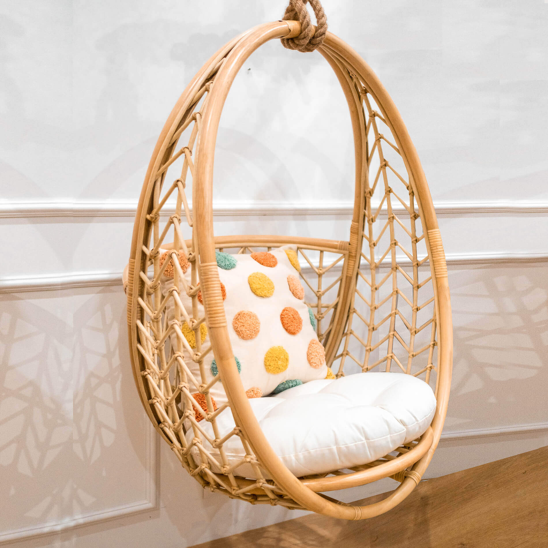 Angled view of the Cross Hatch Hanging Chair by MOMIJI styled indoors.