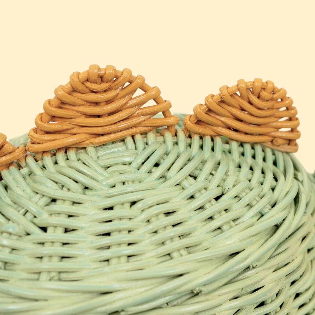 Close up shot of spine spikes of the mint green dinosaur rattan storage basket by MOMIJI