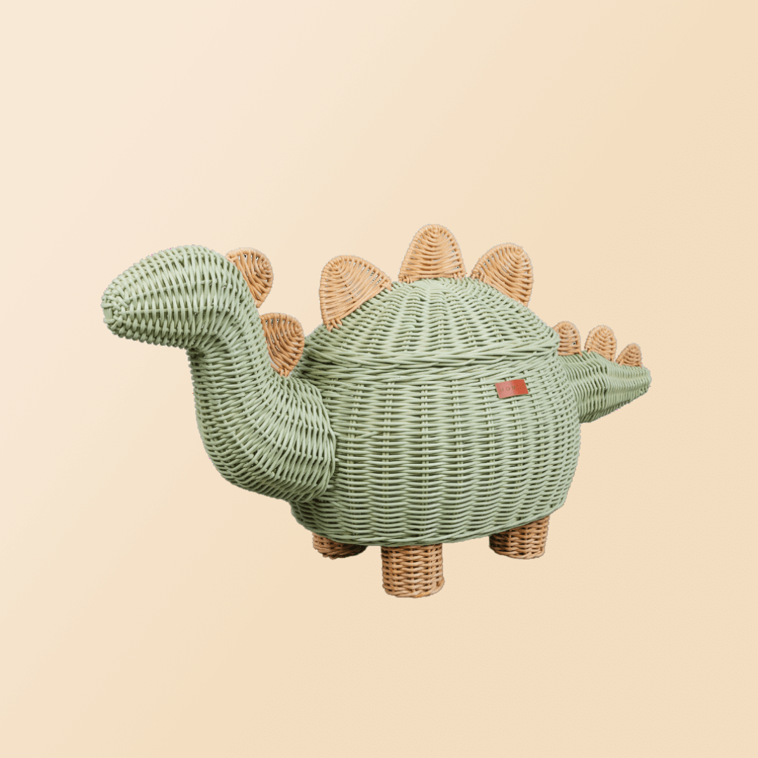 Tilted view of the Mint Green Dinosaur Storage Rattan Basket by MOMIJI in extra large size with beige background.