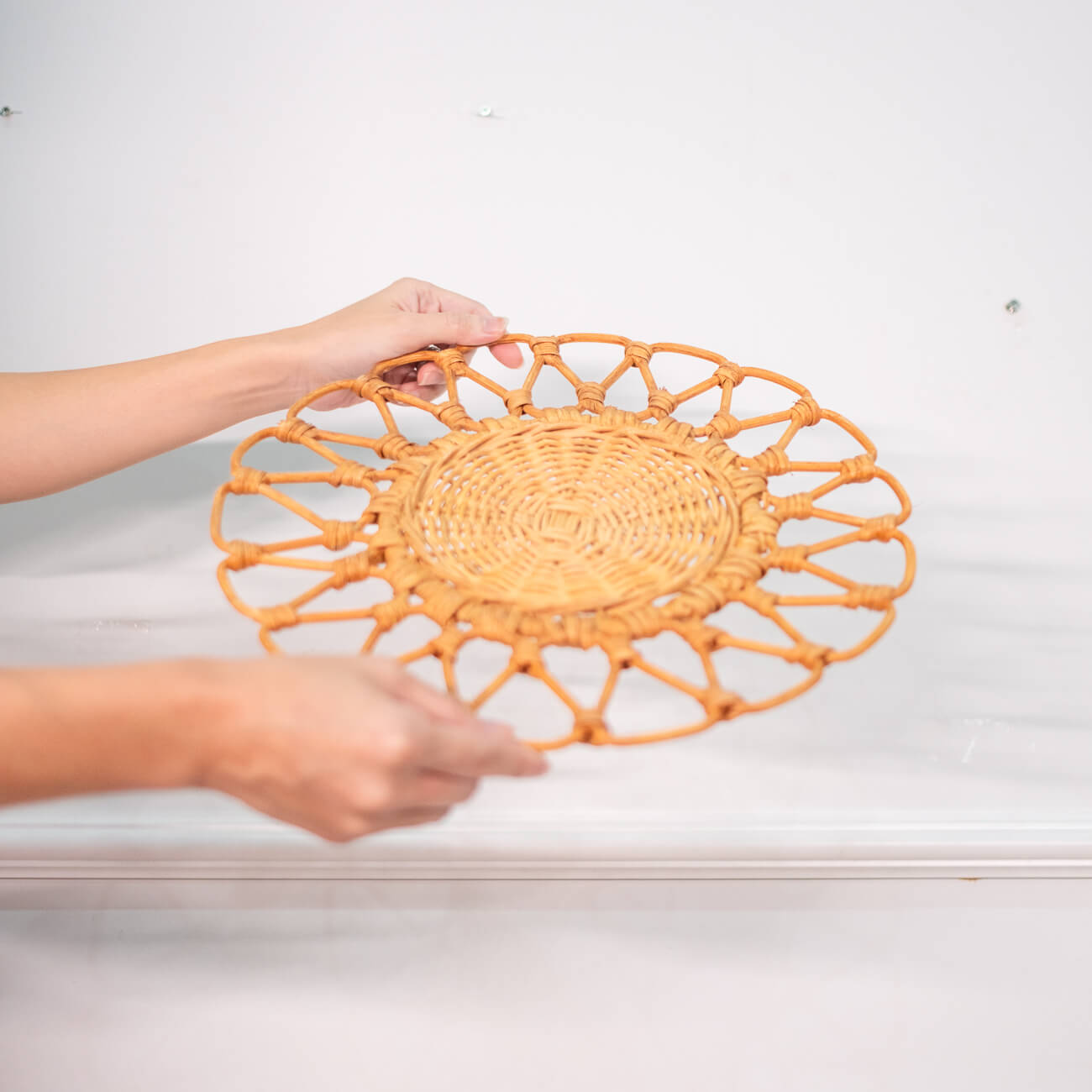 Side view of the Floral placemat by MOMIJI, showing its thickness and woven edge.