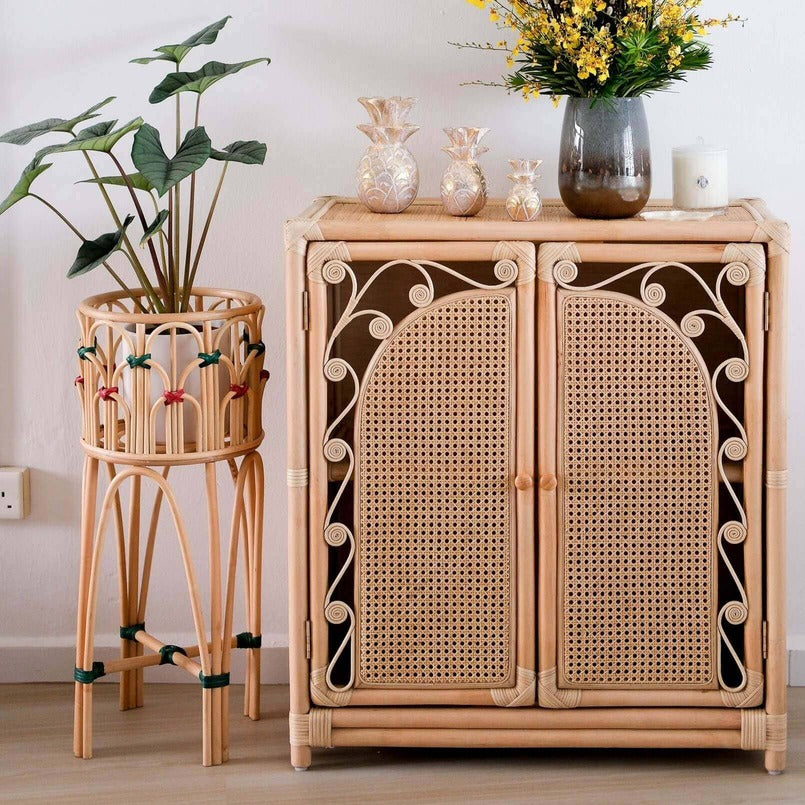 Iris Planter by MOMIJI styled with a potted plant next to a cabinet and decorative vase indoors.