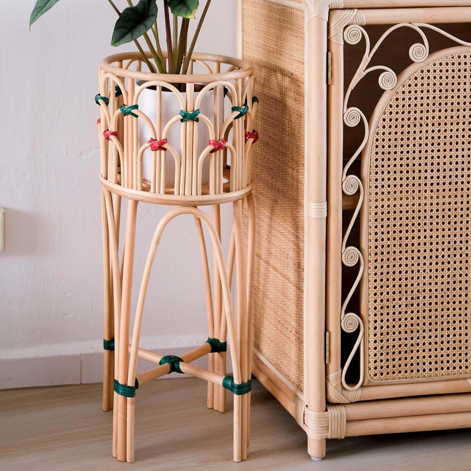 Iris Planter by MOMIJI holding a potted plant, placed beside a cabinet in an indoor setting.