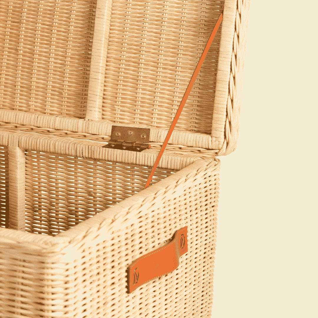 Close-up of the interior side support strap of the handcrafted rattan wicker Leon Leather Trunk by MOMIJI.