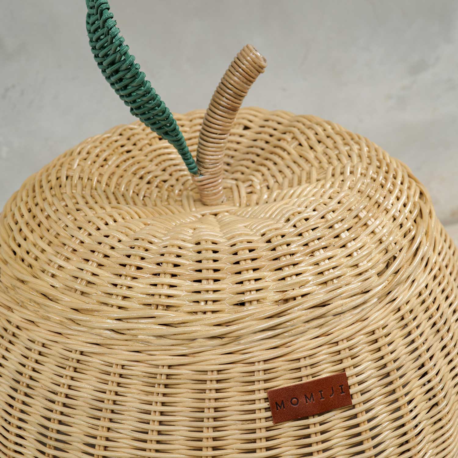 Close up view of natural apple rattan storage basket lid by MOMIJI in medium size.