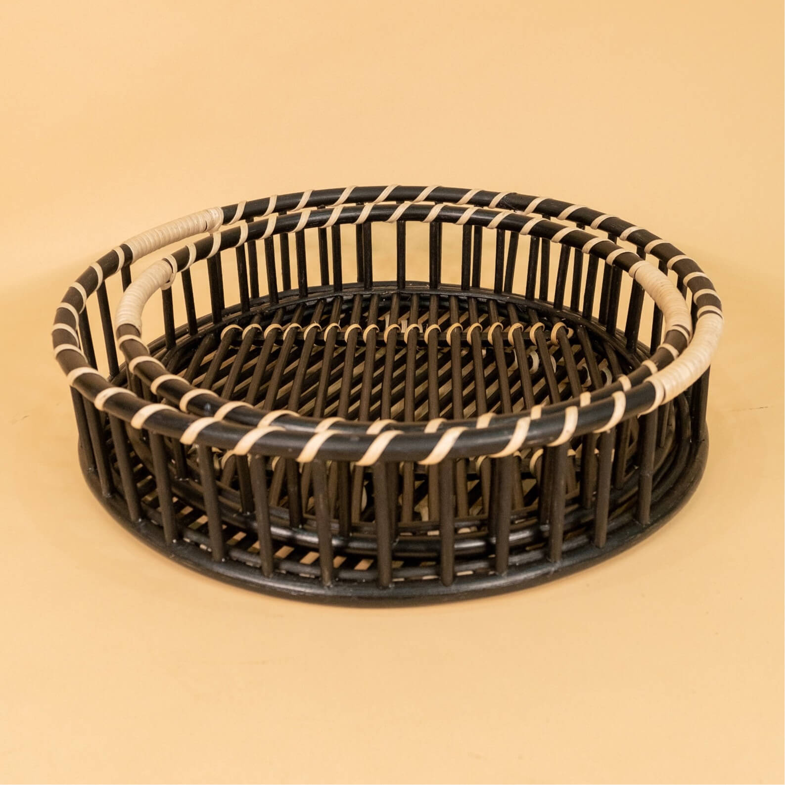 Front view of the Maru Tray Set by MOMIJI showing its woven rattan design.