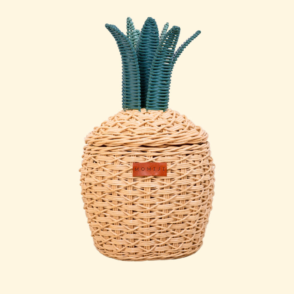 Front view of a handcrafted natural pineapple rattan storage basket in small size, showing the woven design, MOMIJI label, and green crown lid.