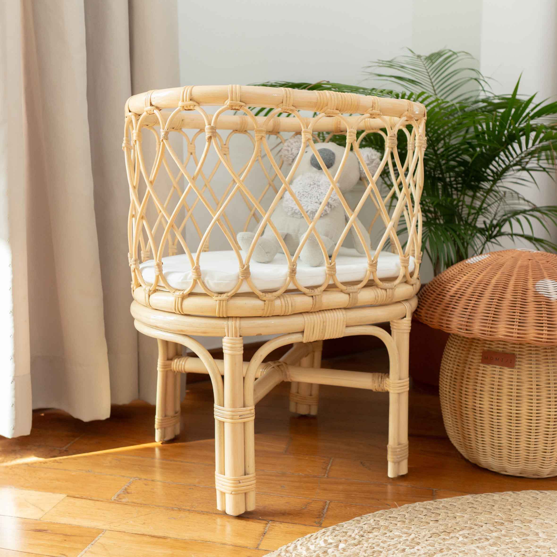 Olivia Doll Bassinet by MOMIJI highlighting the carved detail with koala doll inside, styled with a mushroom basket.