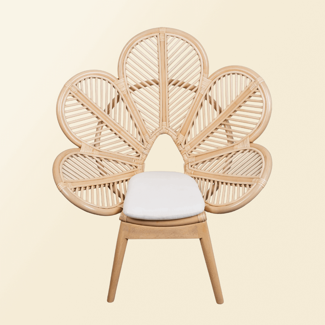 Front view of handcrafted rattan wicker Petal Kids Chair by MOMIJI with white cushion and wooden legs, showing the five-petal flower-shaped backrest for comfortable support.