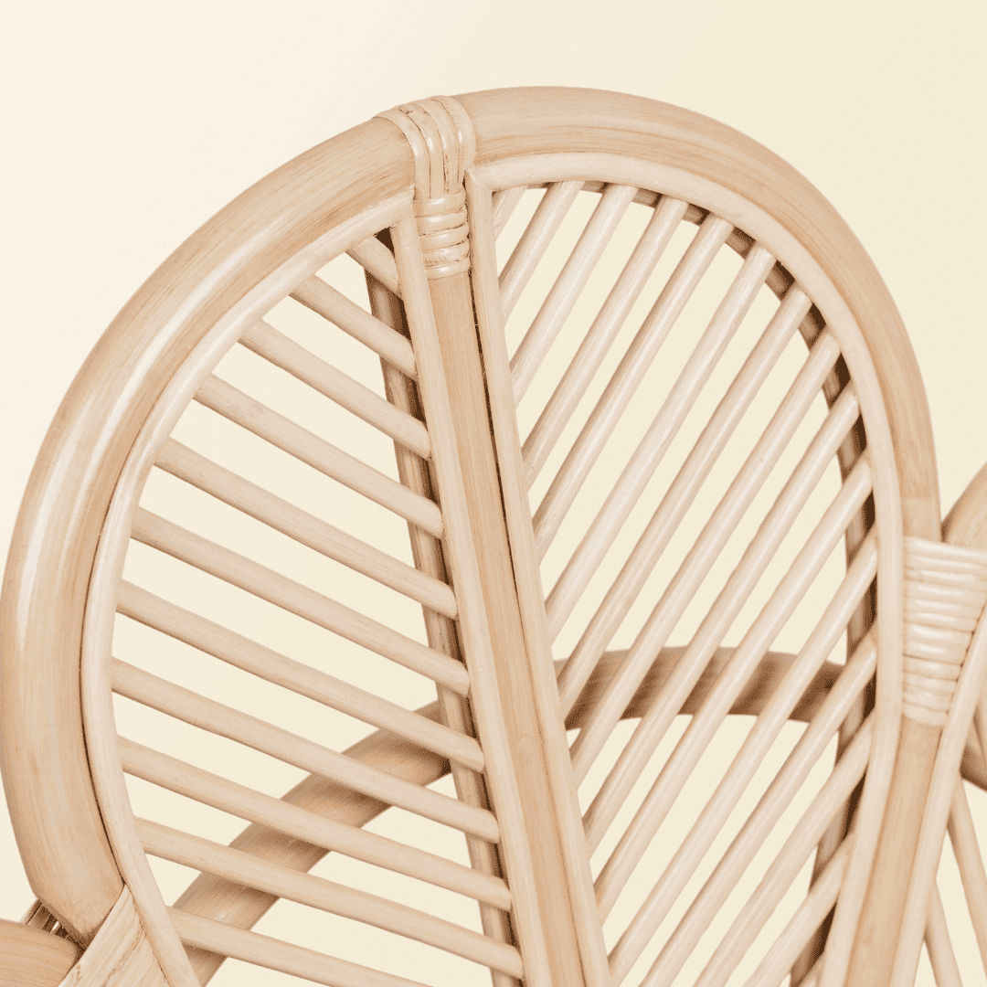 Detail view of the handcrafted rattan wicker Petal Kids Chair by MOMIJI, featuring neatly carved petal edges for stable and comfortable seating.
