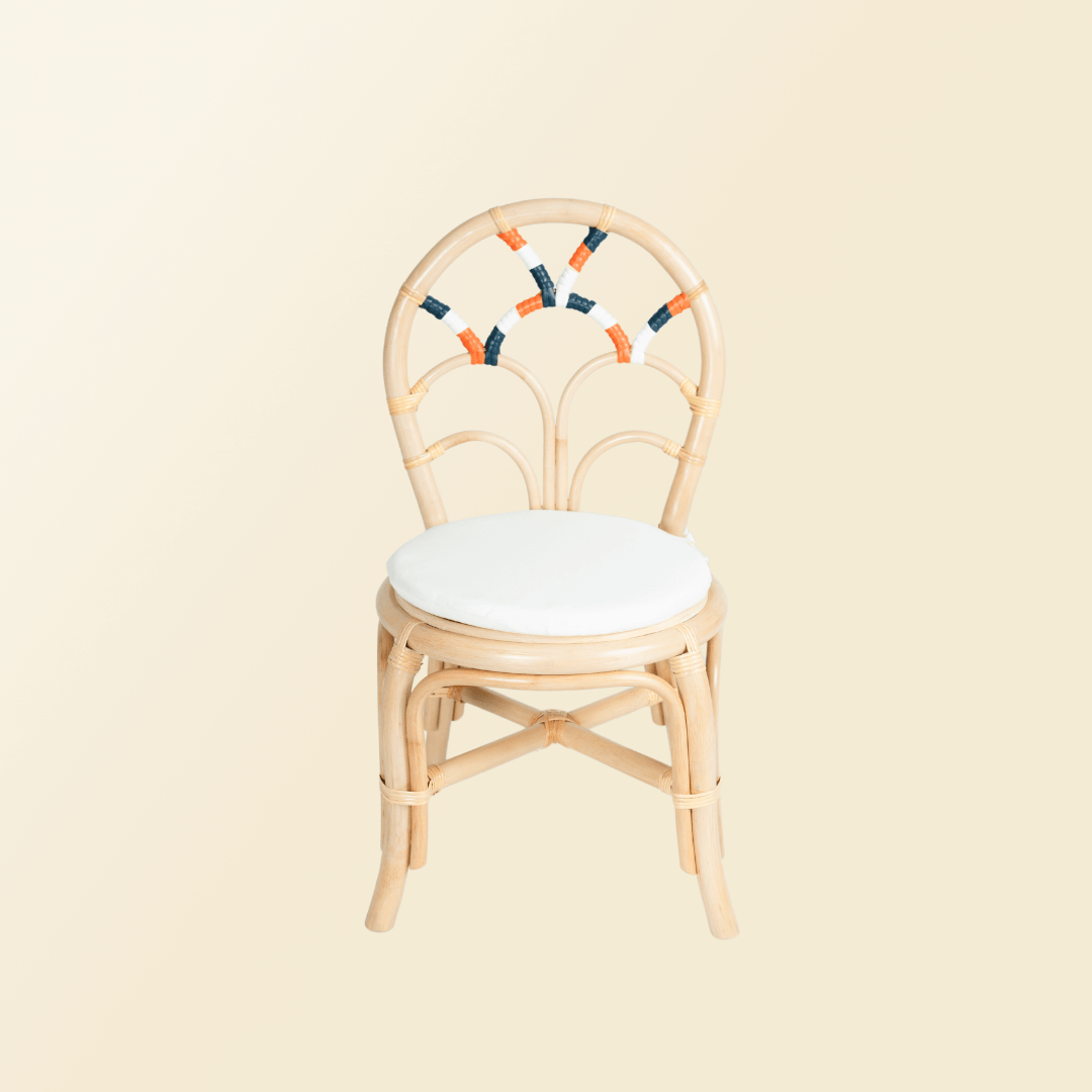 Front view of handcrafted rattan and wicker Quentin Kids Chair by MOMIJI in natural color with white cushion, designed for comfortable kids seating.