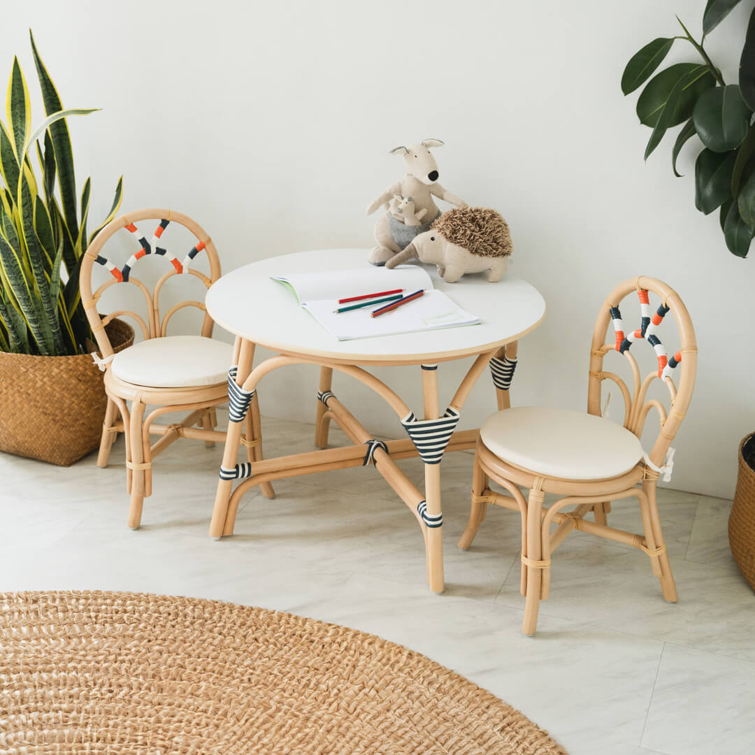 Handcrafted rattan wicker Quentin Kids Chair and table set by MOMIJI styled with toys, suitable for kids playrooms.