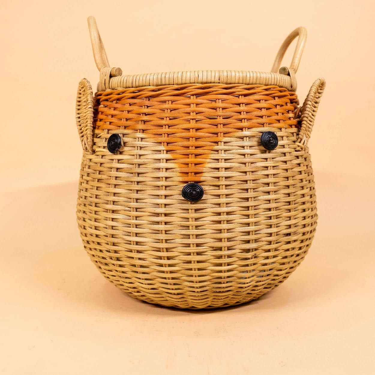 Front view of the Reindeer Rattan Storage Basket by MOMIJI, showing the reindeer face design.