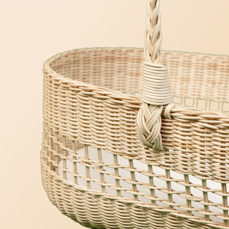 Close-up of the handwoven rattan detail of the Vera Moses Basket by MOMIJI without the cushion.