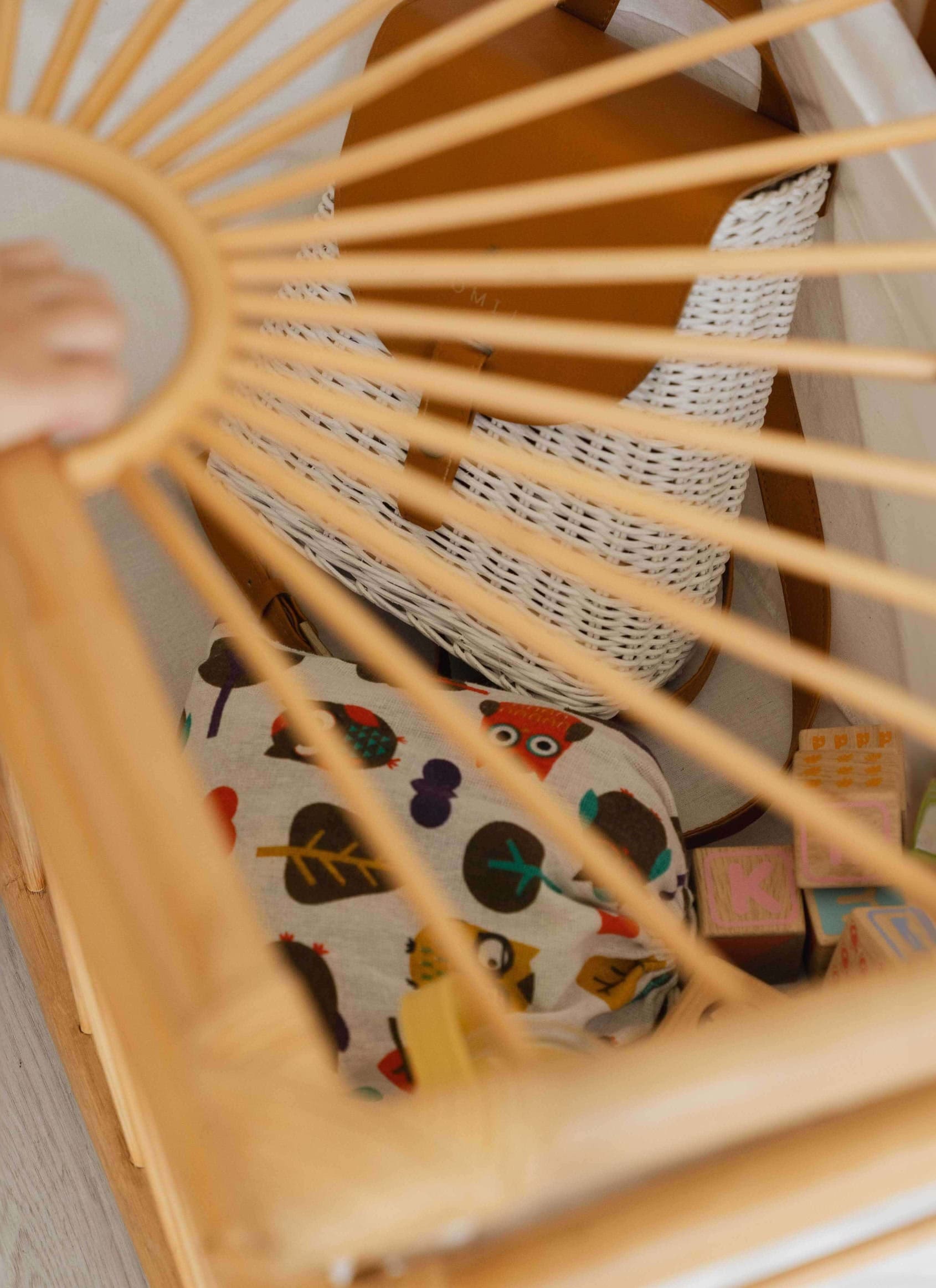 Top view of the wicker Xander Trunk by MOMIJI showing the interior filled with toys.