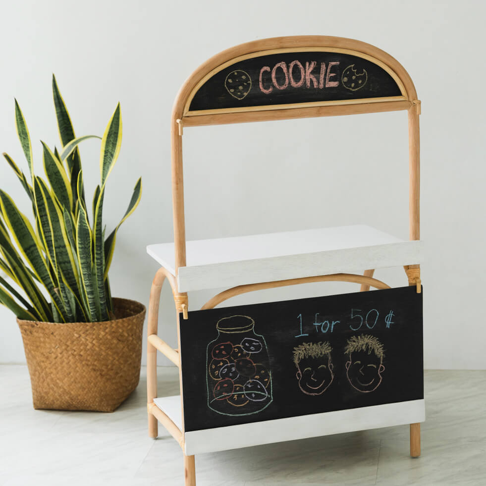 Back view of the 3-in-1 play furniture by MOMIJI showing the chalkboard design in a room with indoor plants.