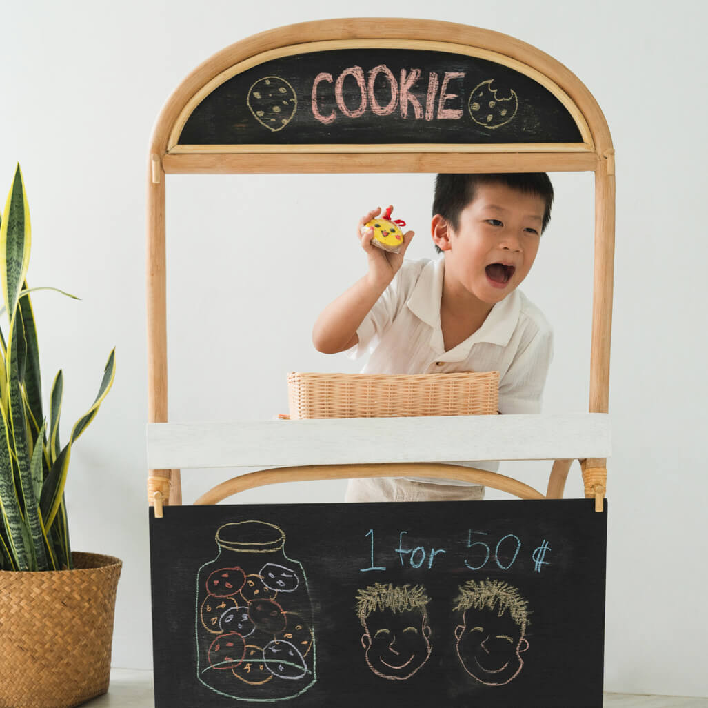 Child playing cookie shop using the modified back side of the 3-in-1 furniture by MOMIJI.