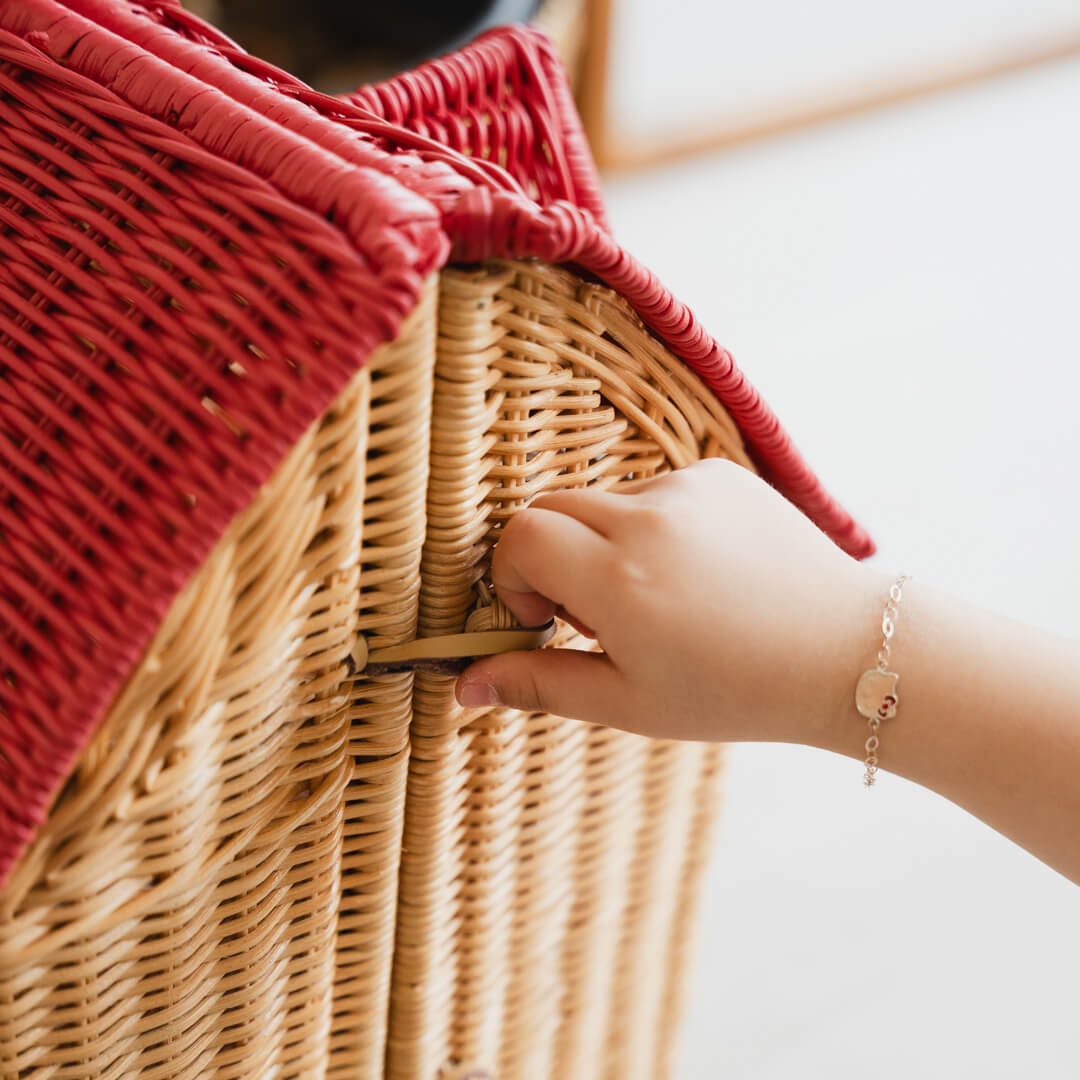 Close-up of a child’s hand opening the door of the Amy Dollhouse Tote by MOMIJI.