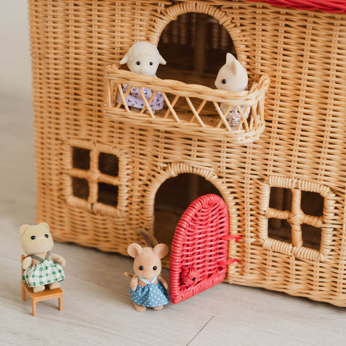 Close-up of the front of the Amy Dollhouse Tote by MOMIJI with its door open, showing small figurines displayed on both floors.