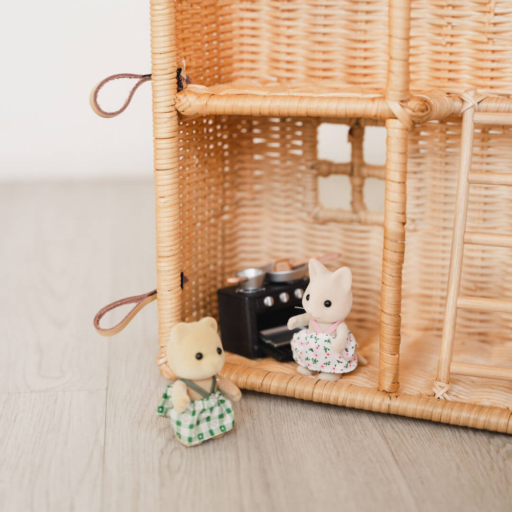 Close-up of the lower floor interior of the Amy Dollhouse Tote by MOMIJI, featuring a kitchen play scene with figurines and a staircase.