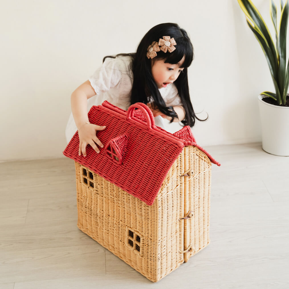 Child exploring the front of the Amy Dollhouse Tote by MOMIJI in a cozy room setting.