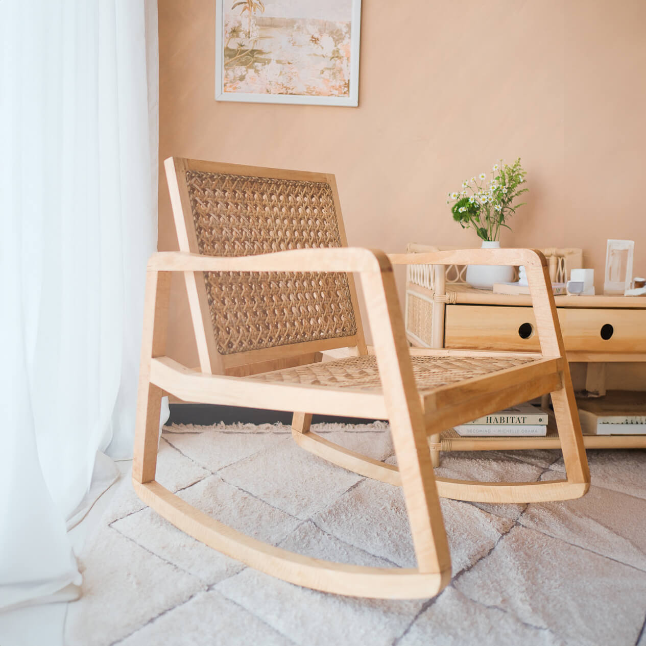 Side view of the Anya Rocking Chair by MOMIJI in a room with a bedside table.