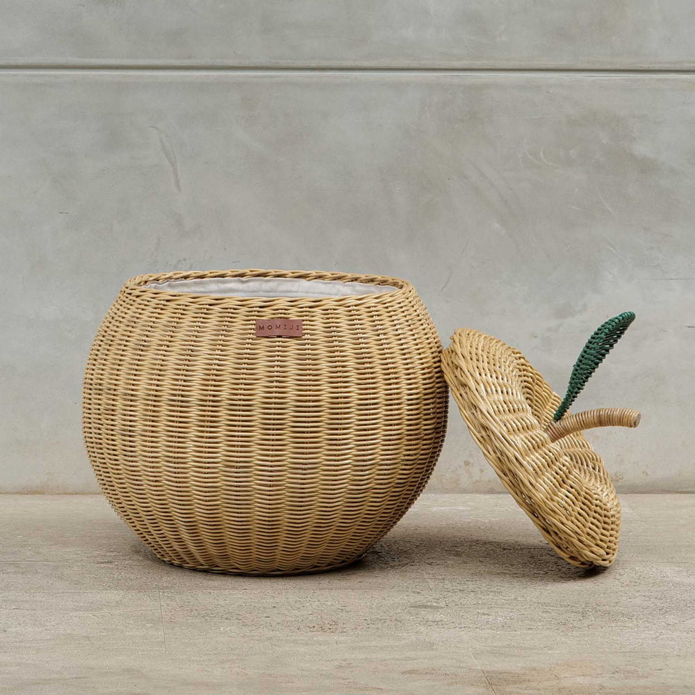 Front view of an opened natural apple rattan storage basket by MOMIJI in medium size, with lid leaning beside the basket.