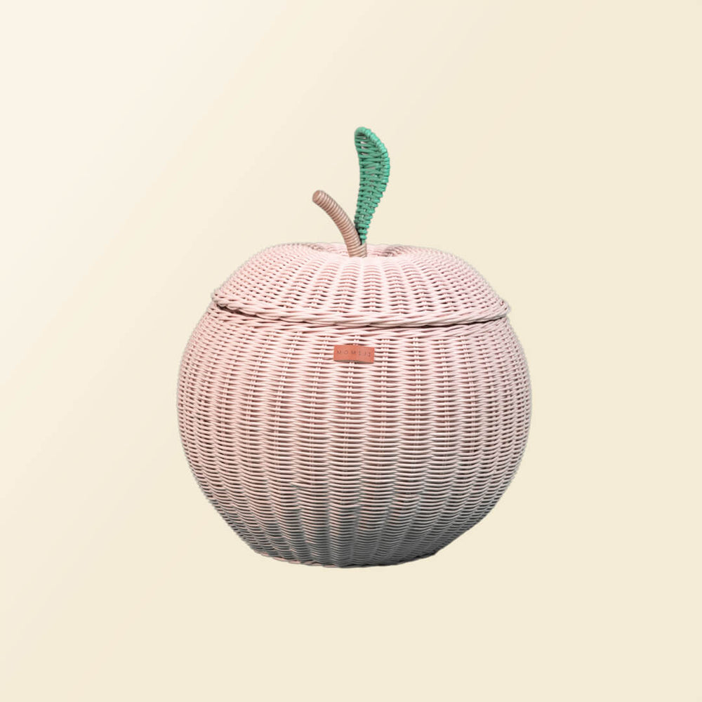 Close up front view of a pink apple rattan storage basket by MOMIJI.
