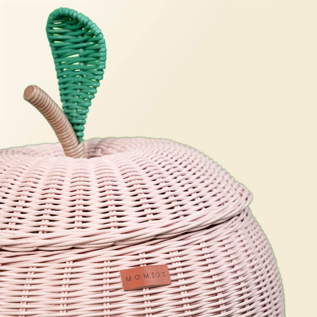 Close up view of the lid of pink apple rattan storage basket by MOMIJI.
