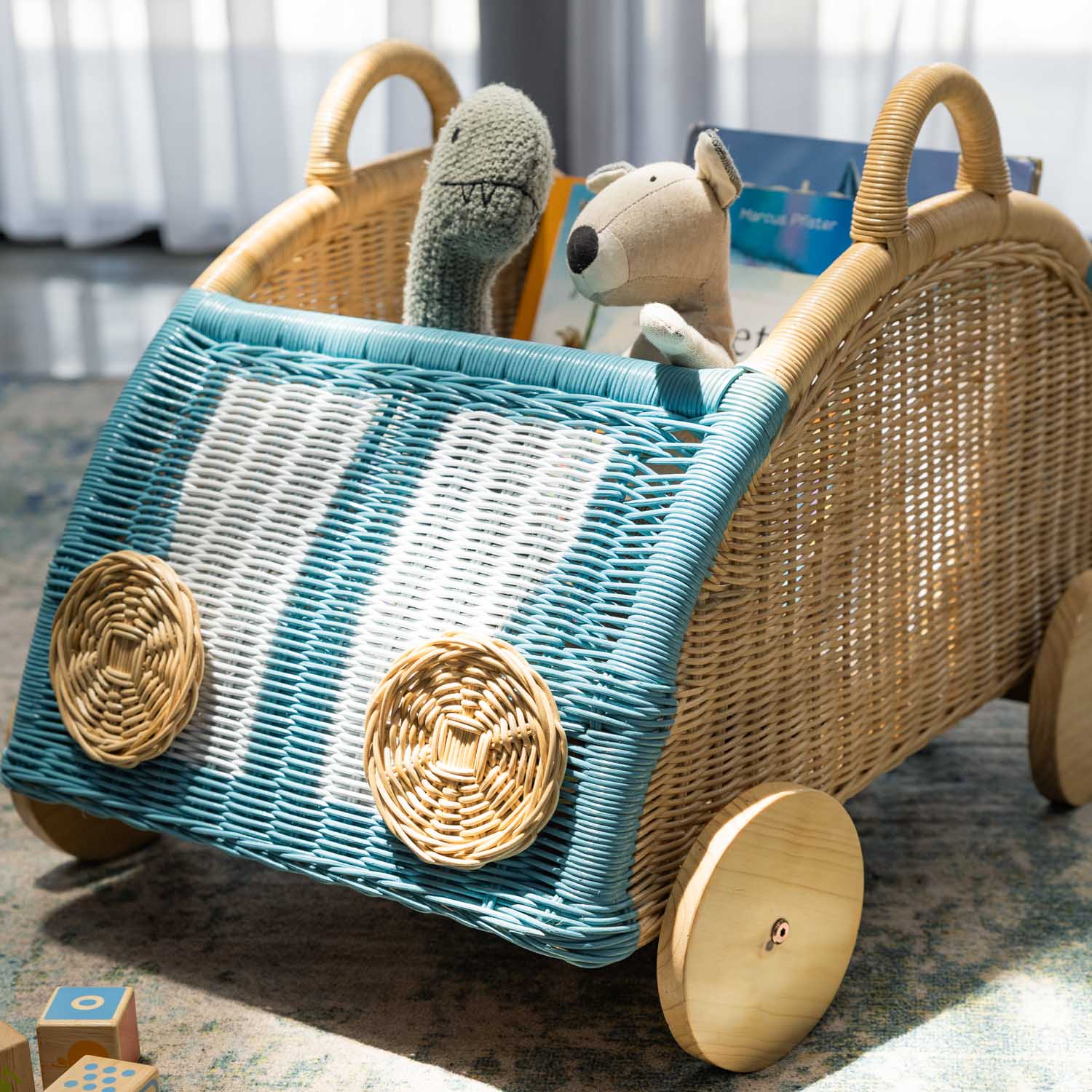 Close-up of the front and side detail of the Archie Storage Wagon by MOMIJI filled with toys.