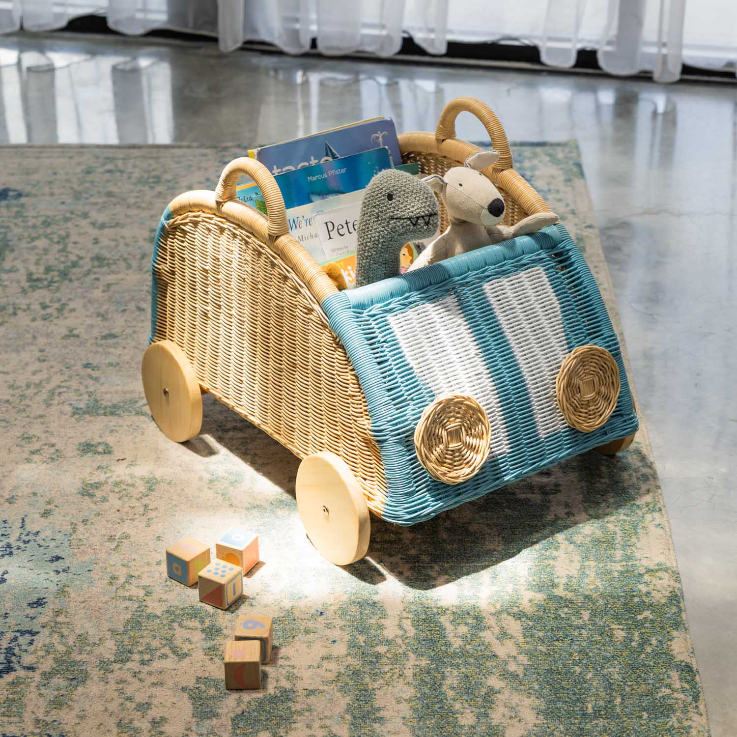 Archie Storage Wagon by MOMIJI filled with toys and colorful blocks in an indoor setting.