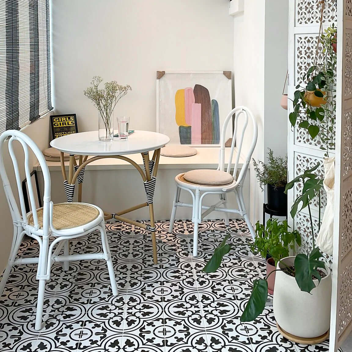 Aulia Dining Table & Chairs Set by MOMIJI styled in a small dining area with decorative elements on a patterned floor.