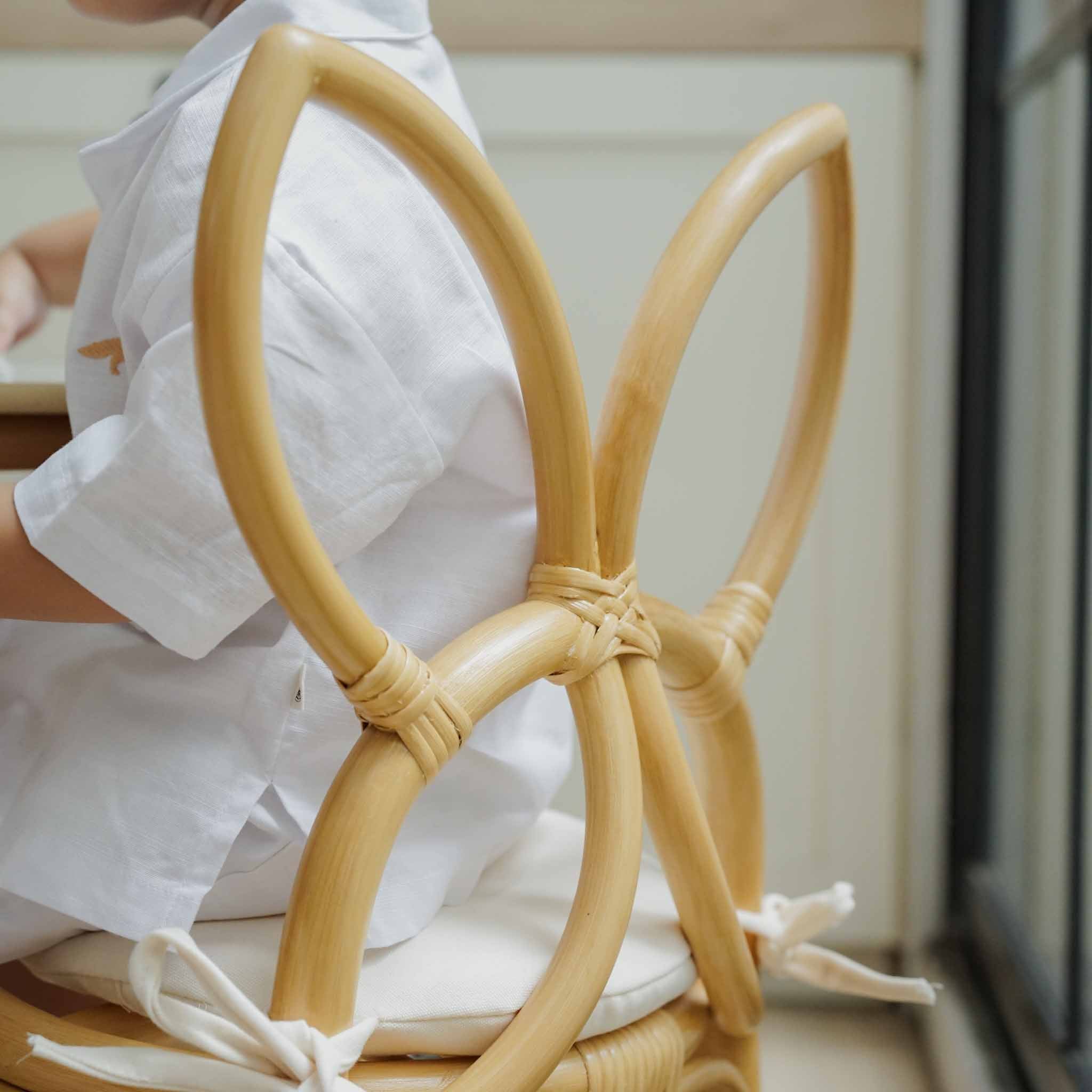 Back view of a handcrafted Butterfly Kids Chairs (Natural) by MOMIJI showing the details of the butterfly-shaped chair back with sturdy rattan wicker.