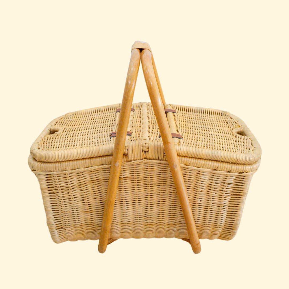 Aurelie rattan picnic basket by MOMIJI with a lid on a beige background.