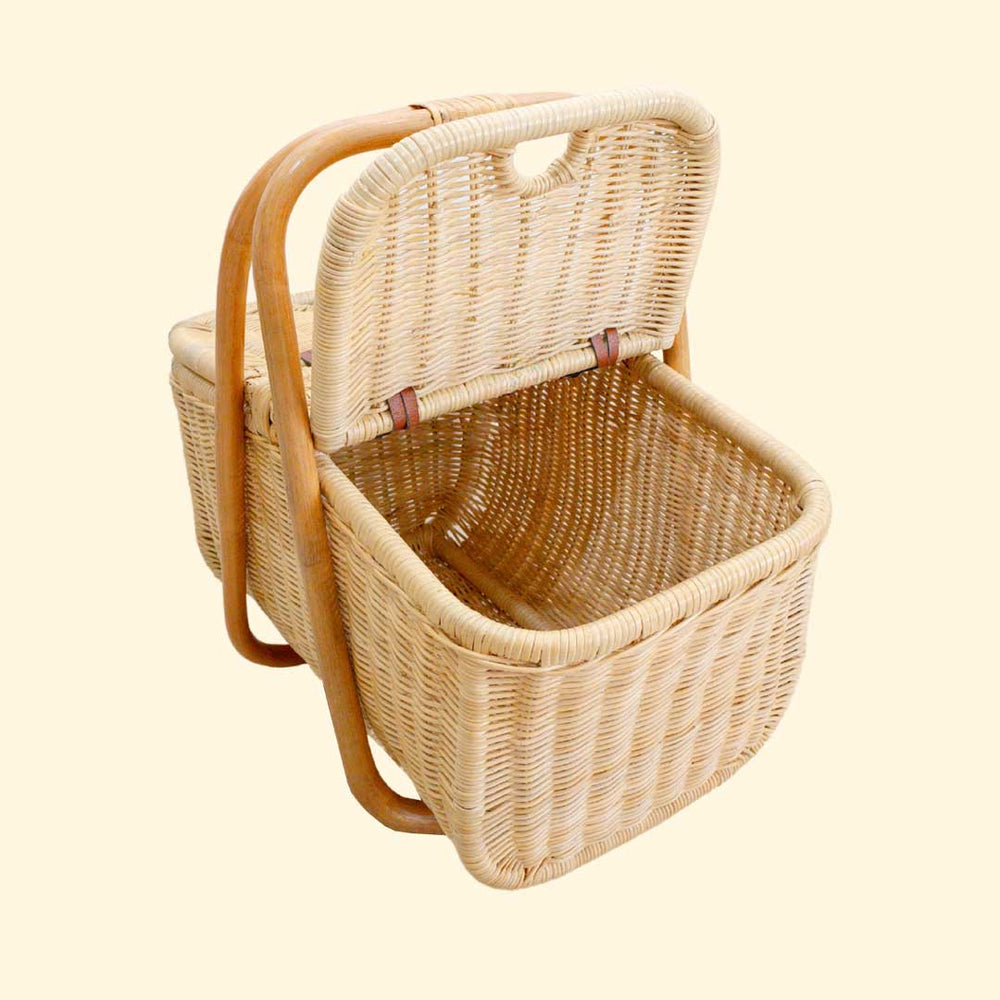 Aurelie rattan picnic basket from MOMIJI with open lid and inside details on a cream background.