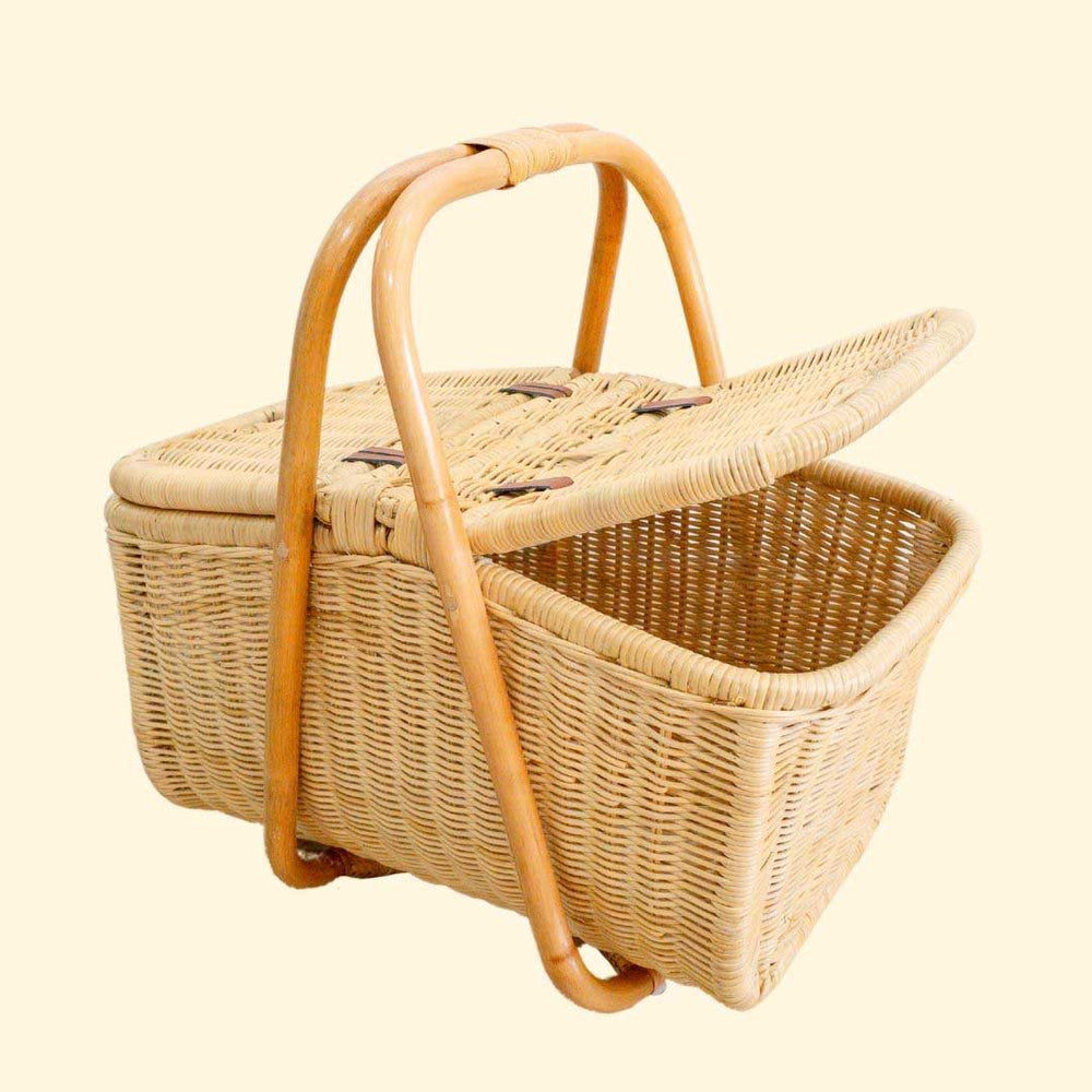 Aurelie rattan picnic basket by MOMIJI  with one open lid on a beige background.