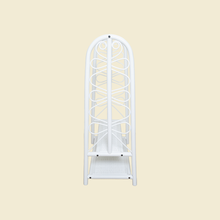 Side view of the handcrafted white rattan Belle Kids Montessori Clothing Rack by MOMIJI, highlighting the decorative side panels, hanging rail, two storage shelves, and easy-to-assemble construction.
