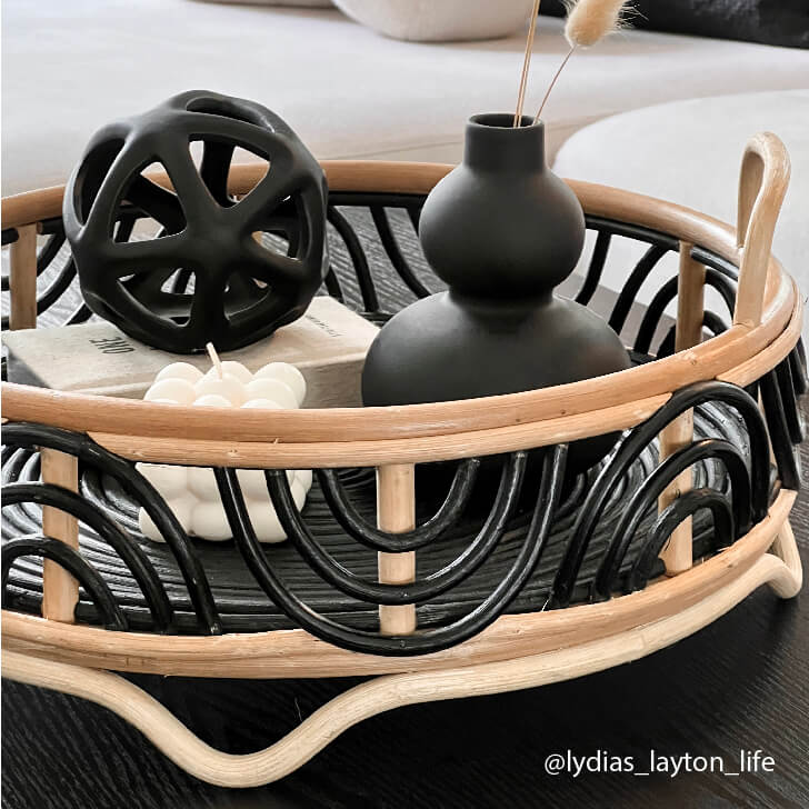Decorative items including a black vase and sculptural object arranged on the Belle Tray by MOMIJI.