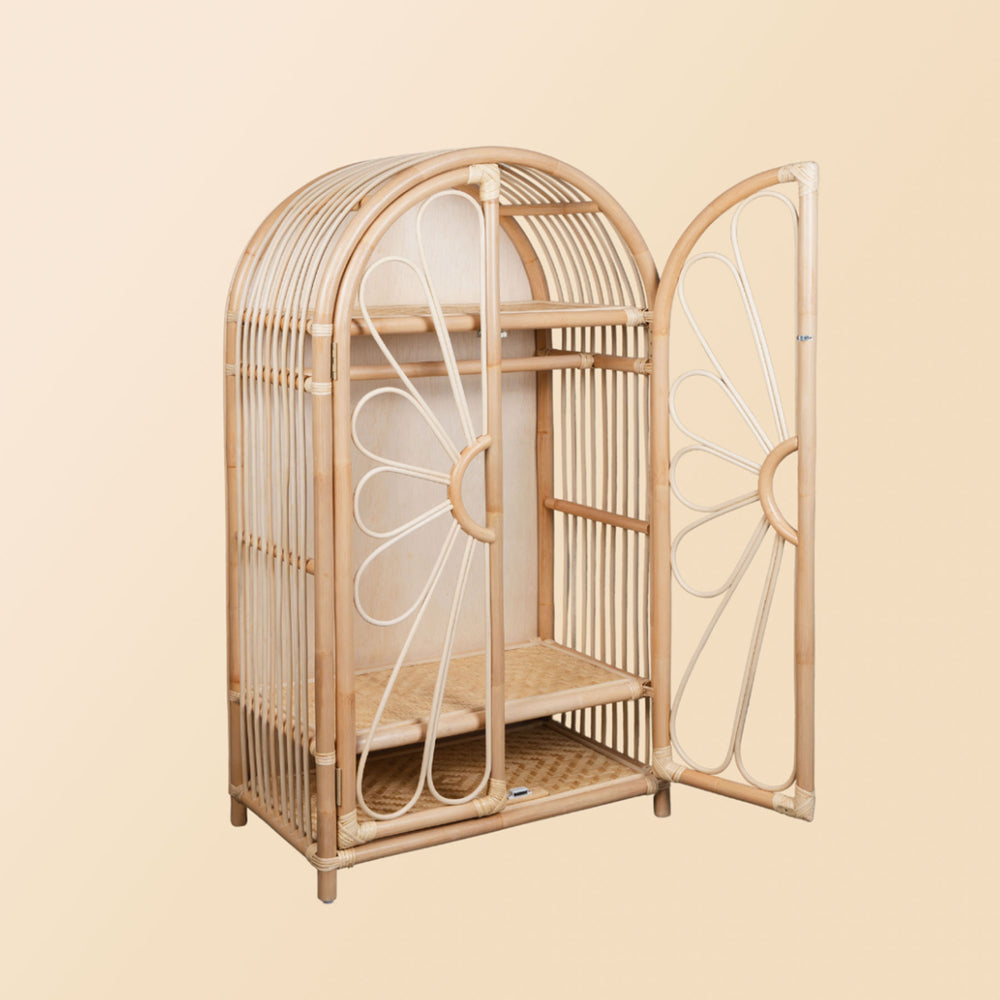 View of rattan wicker wardrobe flower motif by MOMIJI with one cabinet door open. Clothing rack and display shelves inside are all visible