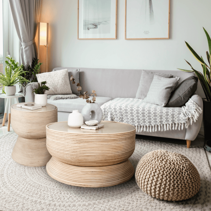 Charme Coffee Table and side table by MOMIJI displayed together on a rug with a sofa behind.