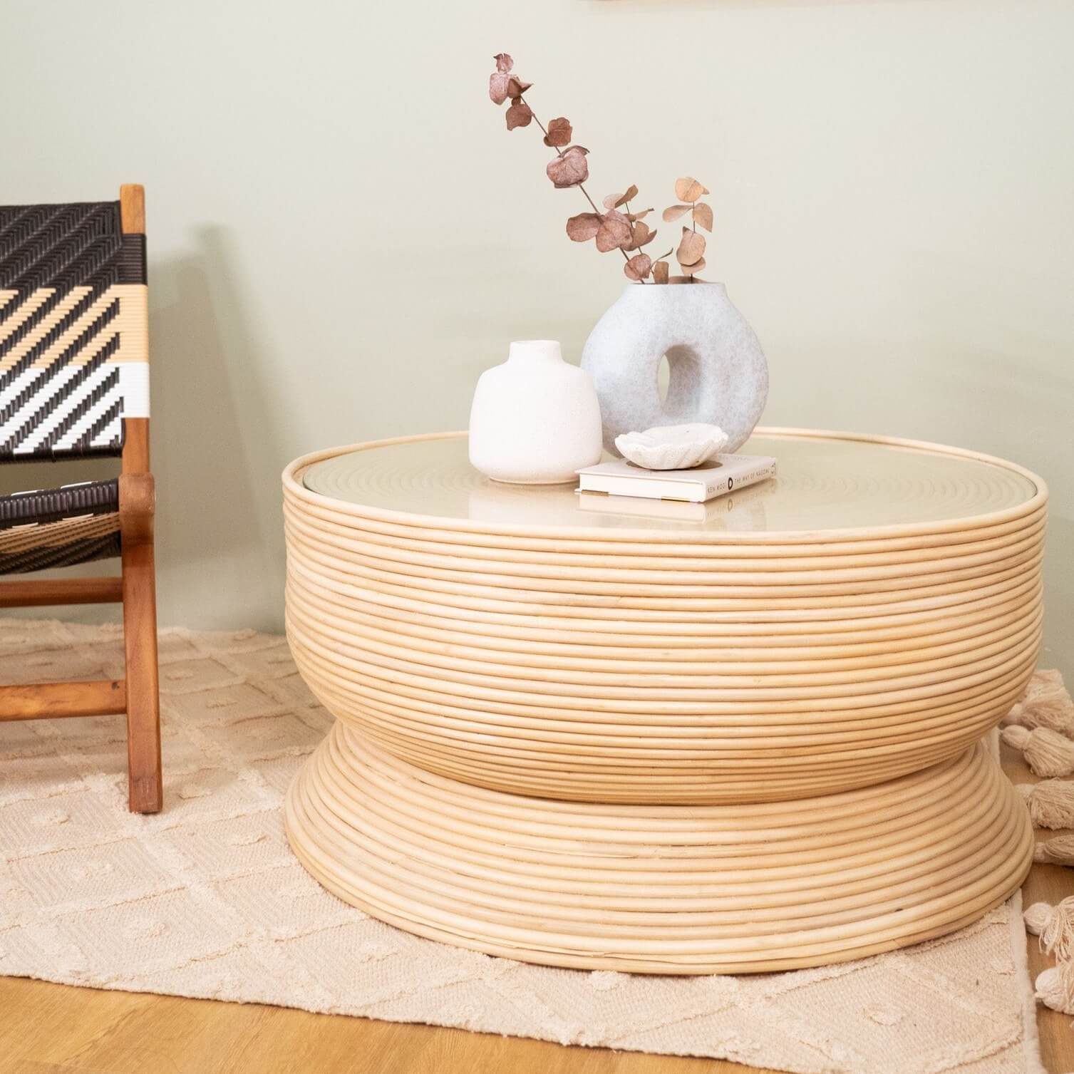 Charme Coffee Table by MOMIJI placed on a rug with a vase of dried flowers, styled in a cozy living space.