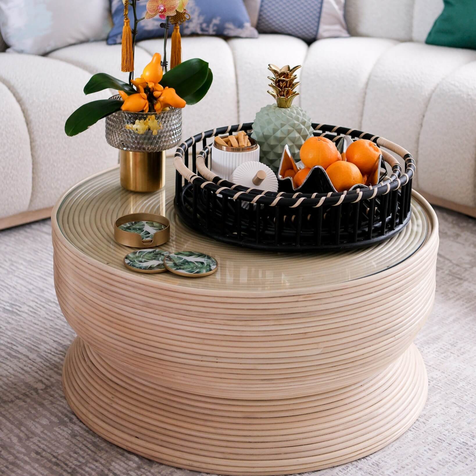 Charme Coffee Table by MOMIJI styled with a fruit basket and vase in a living room.