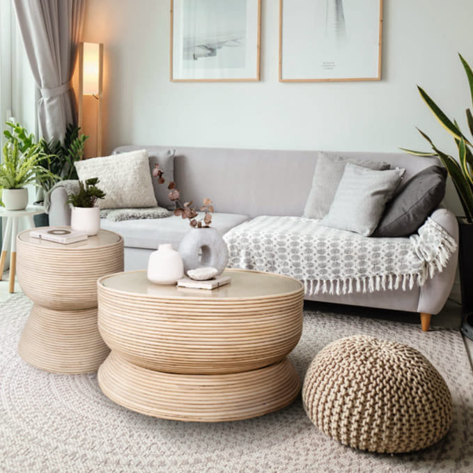 Charme Side Table and coffee table by MOMIJI displayed together on a rug with a sofa behind.