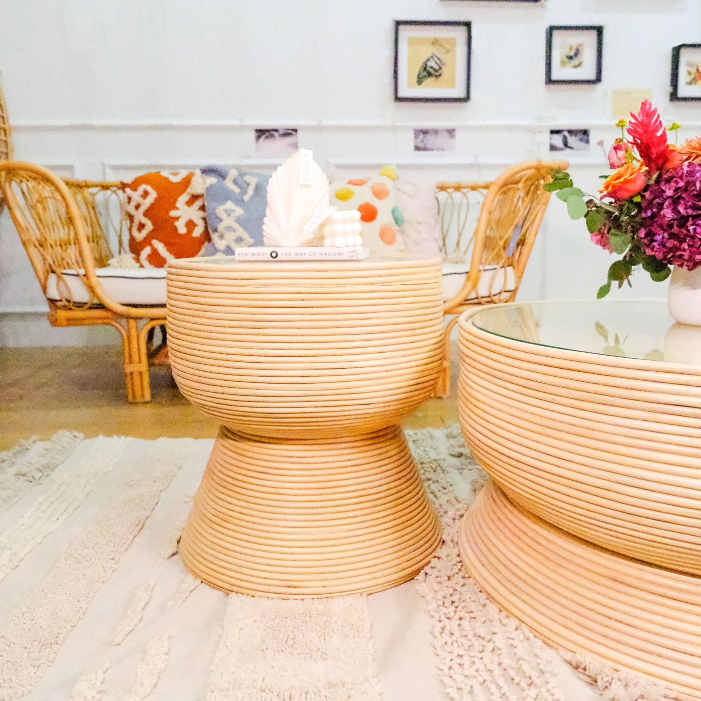 Charme Side Table by MOMIJI styled with books and decor beside a coffee table and couch.