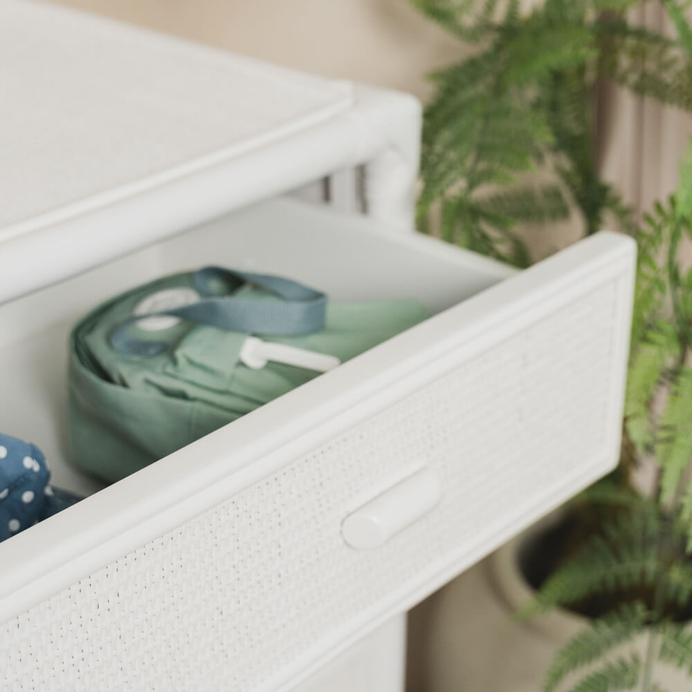 Close-up of an open drawer on the handcrafted rattan wicker Coastal Haven Drawers by MOMIJI, showing woven drawer fronts and integrated pull handle.